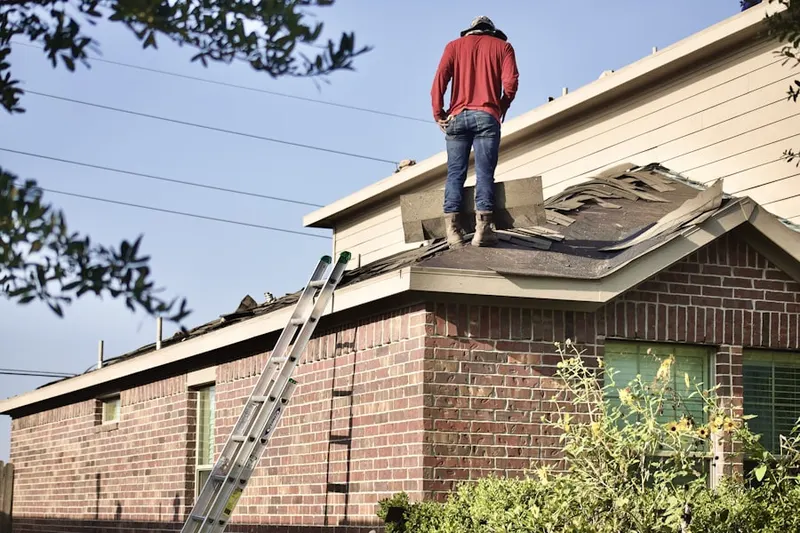 Professional roofer working on a residential roof in Chaffee Park